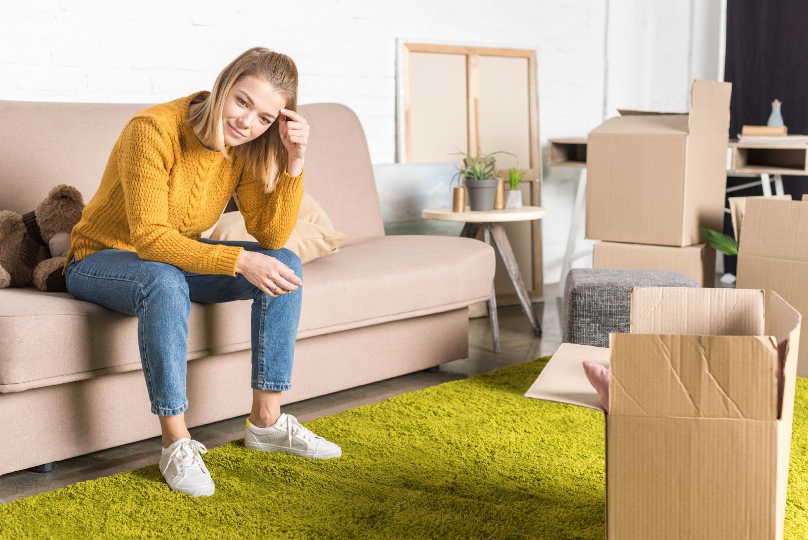 female on couch with green rug